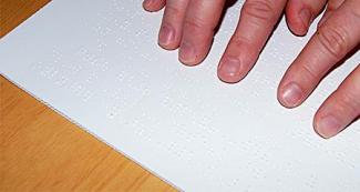 reading_c76b179c-e574-4f83-b290-fcd88bee8a3a.jpg reading Braille with fingers